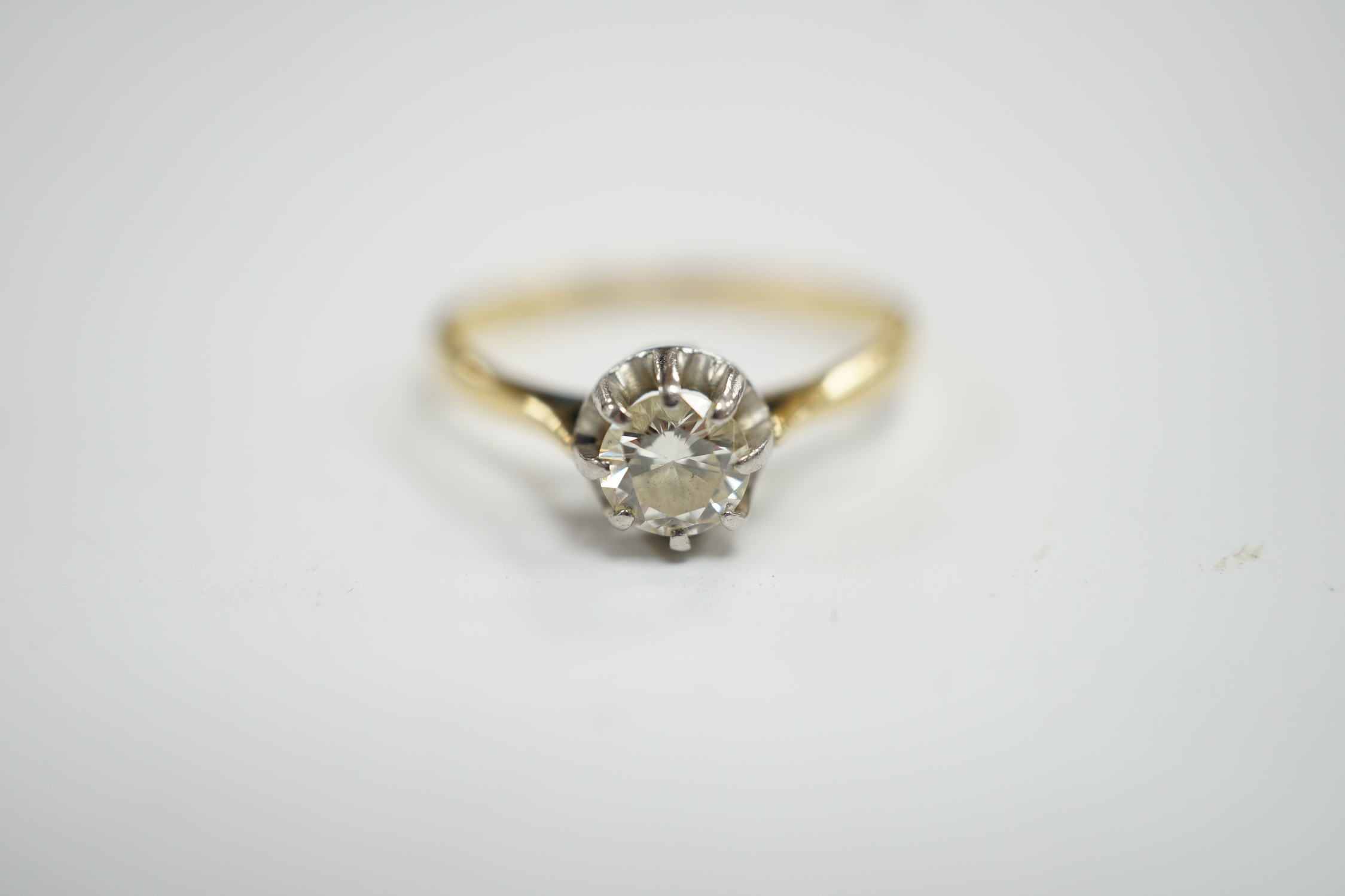 An early 20th century 18ct, plat and claw set solitaire diamond ring, size S, gross weight 2.8 grams.